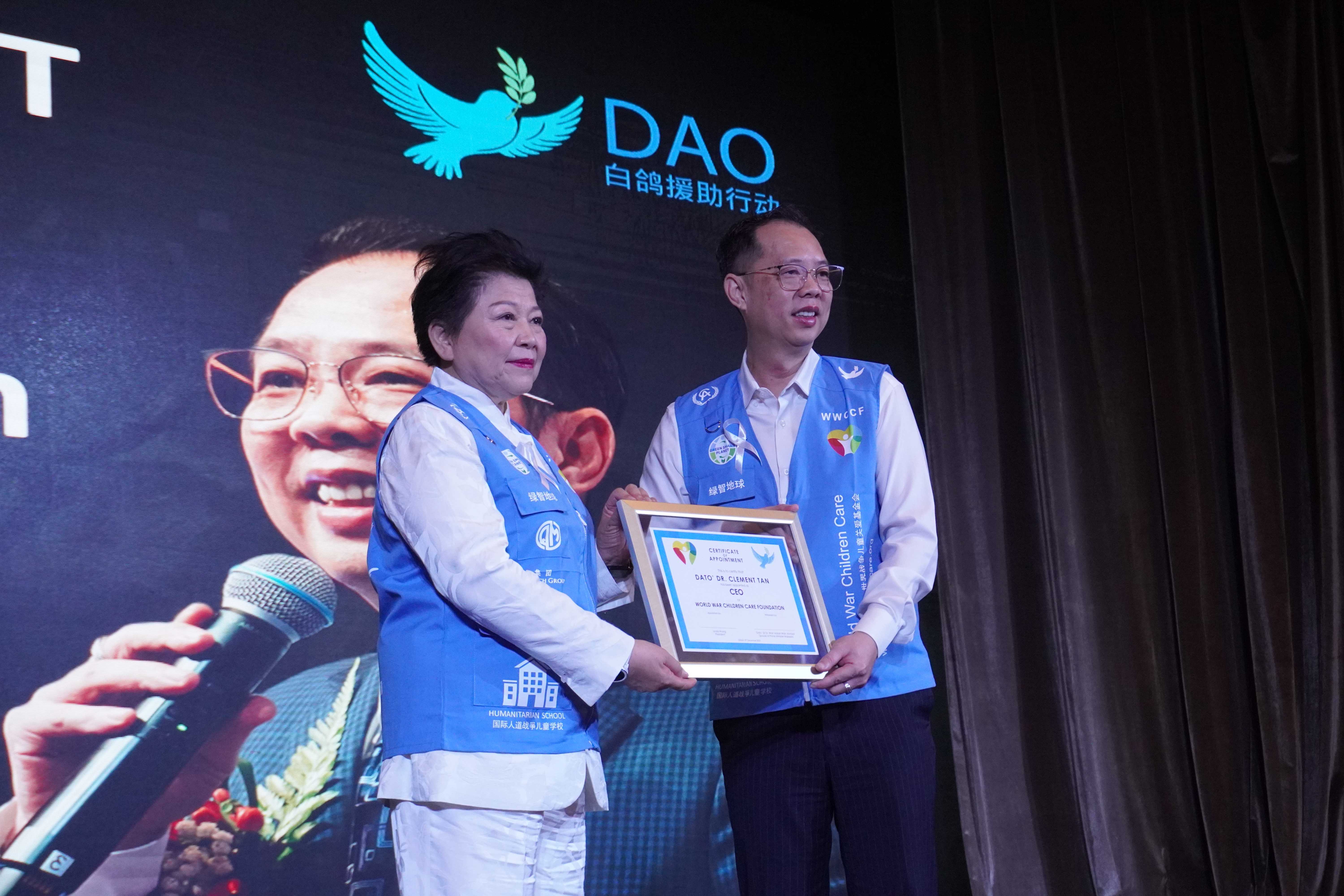 Madam Linda Wong handling certificate of appointment to Dato Dr. Clement Tan